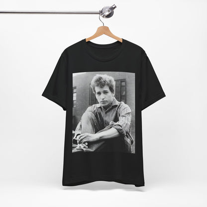 A black graphic t-shirt featuring a graphic of Bob Dylan from his 60s origins in folk music.