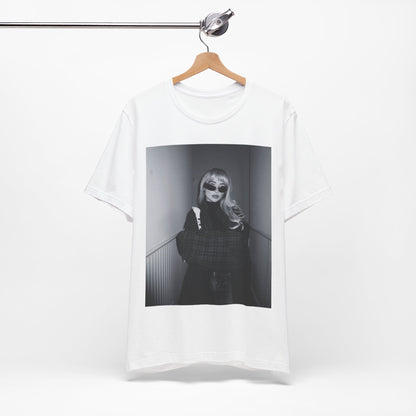 A black graphic t-shirt featuring a black and white glam pop diva graphic of Sabrina Carpenter.