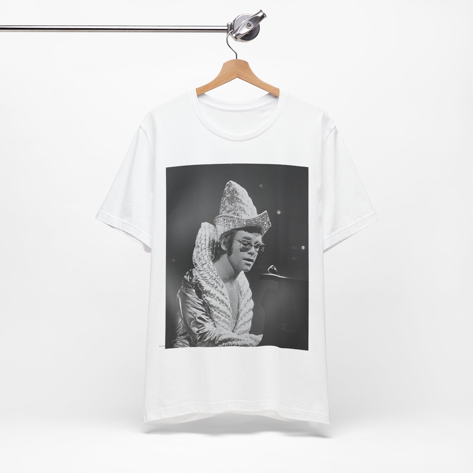 A black graphic t-shirt featuring a 70s pop aesthetic graphic of Elton John.
