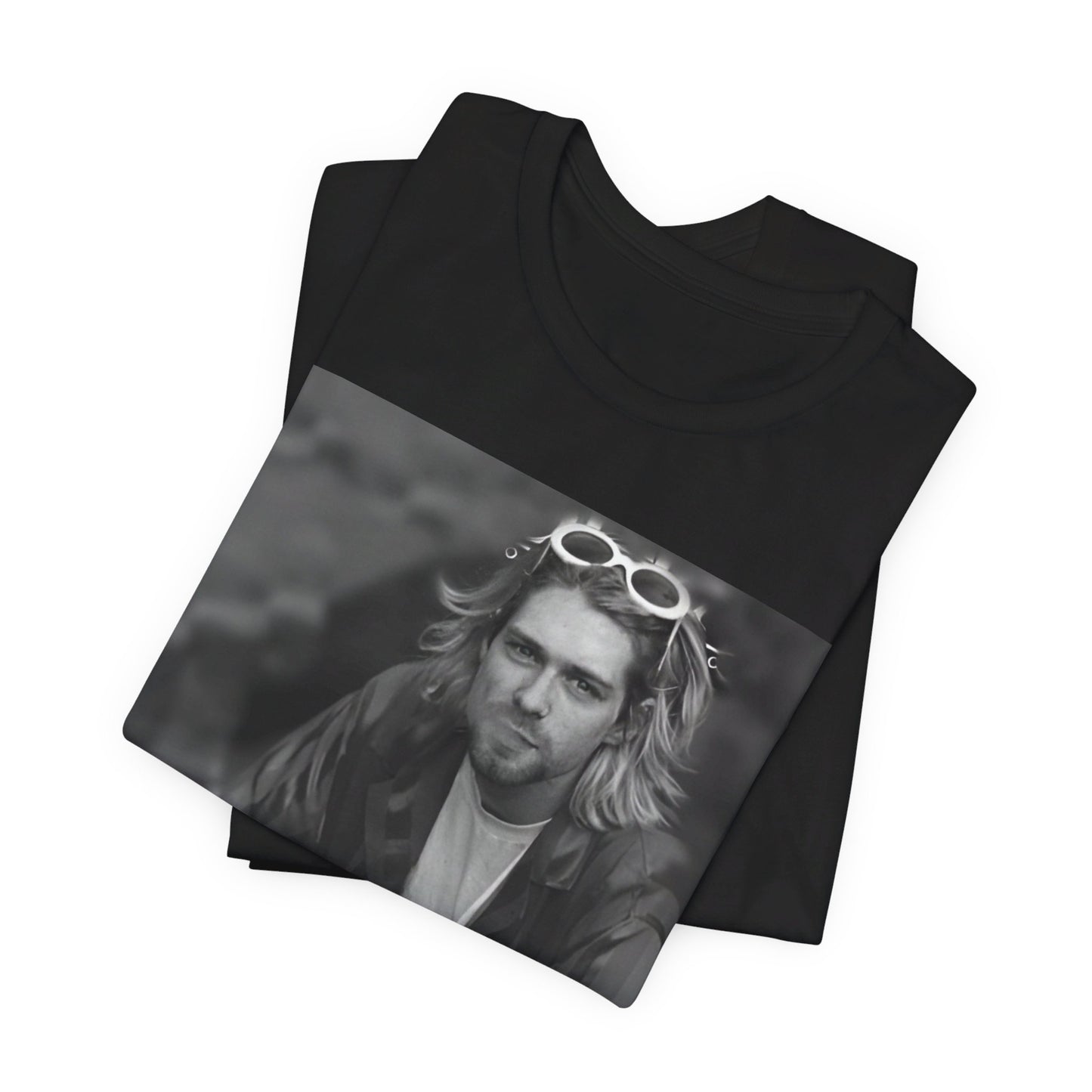 A black graphic t-shirt featuring a 90s black and white photo portrait of Kurt Cobain from Nirvana.