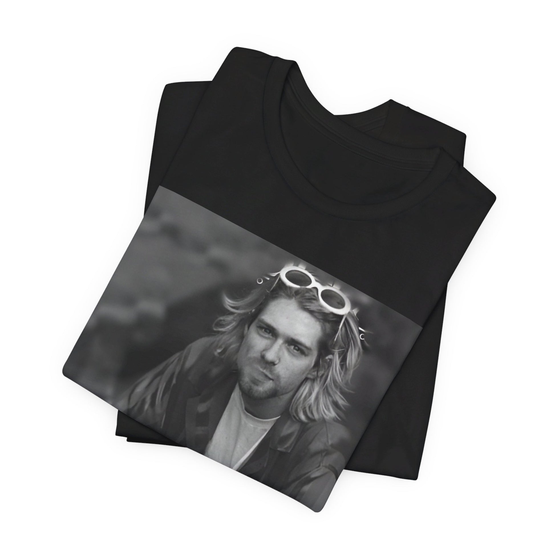 A black graphic t-shirt featuring a 90s black and white photo portrait of Kurt Cobain from Nirvana.