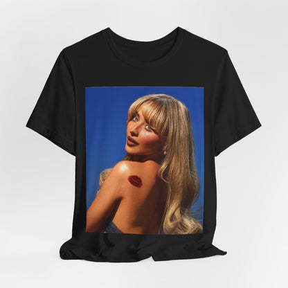 A black graphic t-shirt featuring a stylized graphic of Sabrina Carpenter, designed with a modern pop aesthetic.