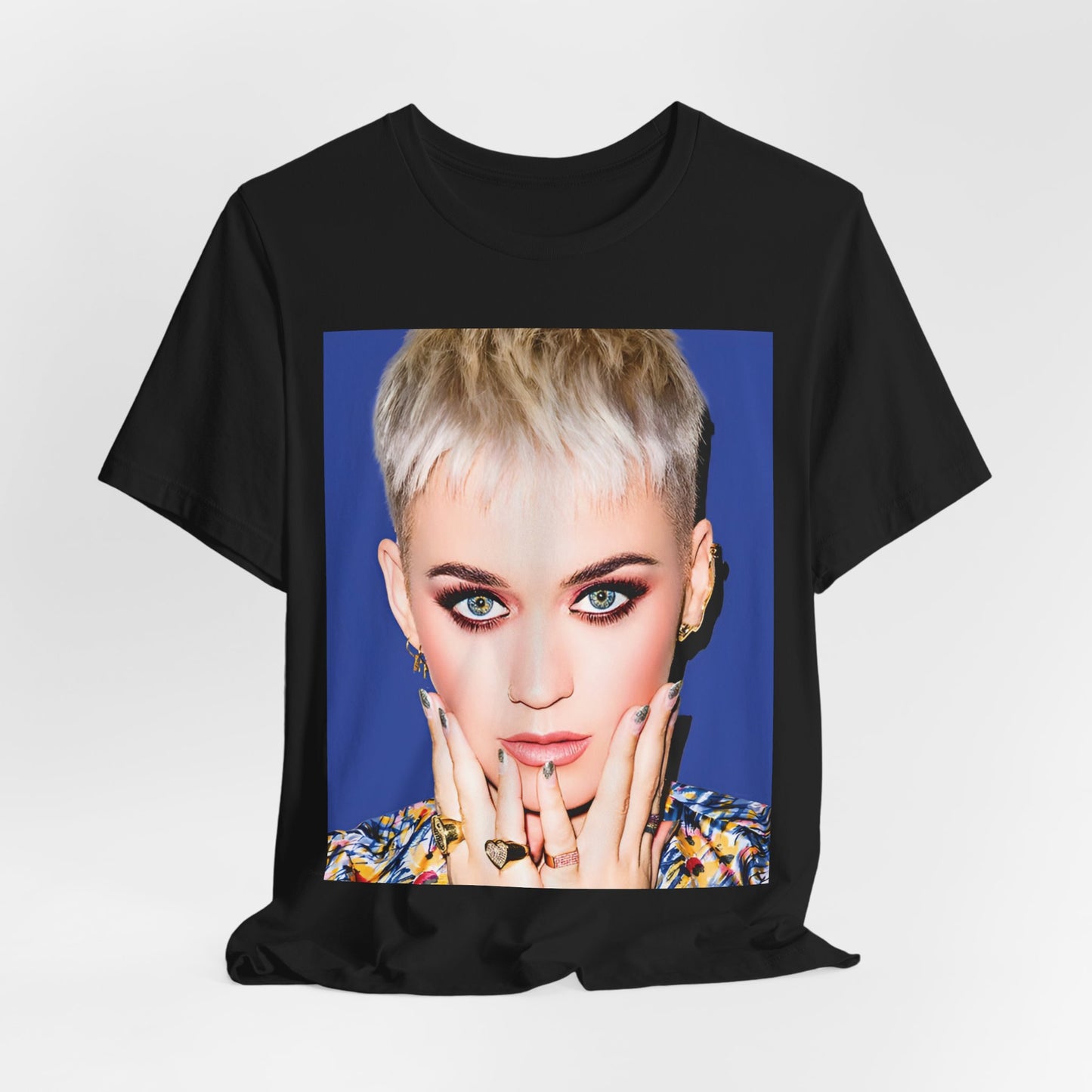 A black graphic t-shirt featuring a graphic of Katy Perry as a global pop phenomenon.