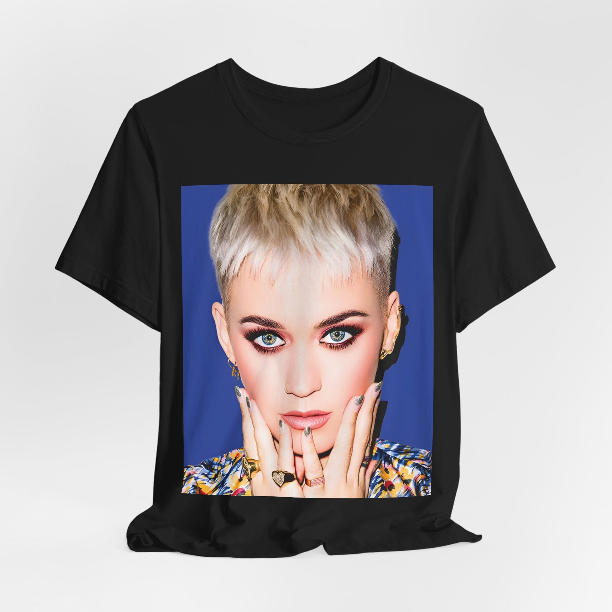 A black graphic t-shirt featuring a graphic of Katy Perry as a global pop phenomenon.