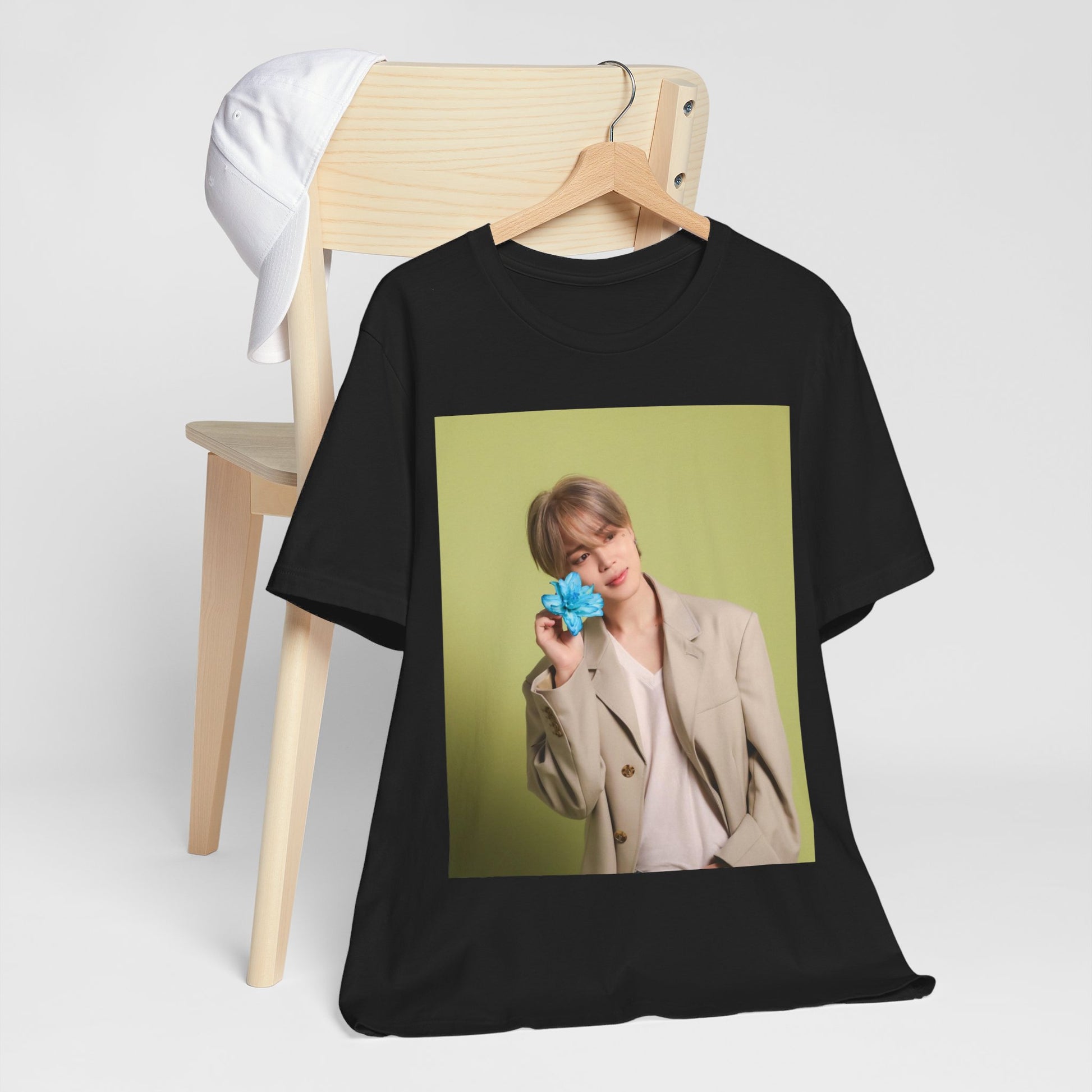 A black graphic t-shirt featuring a vintage K-Pop aesthetic graphic of Jimin.