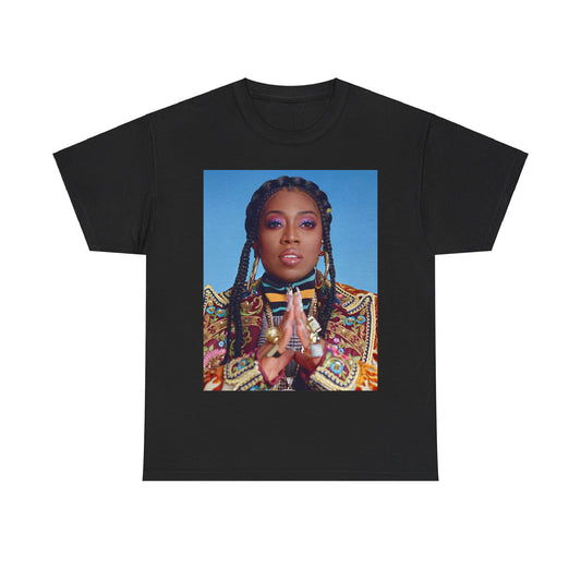 A black graphic t-shirt featuring a graphic of Missy Elliott with a cool, futuristic rap fashion aesthetic.