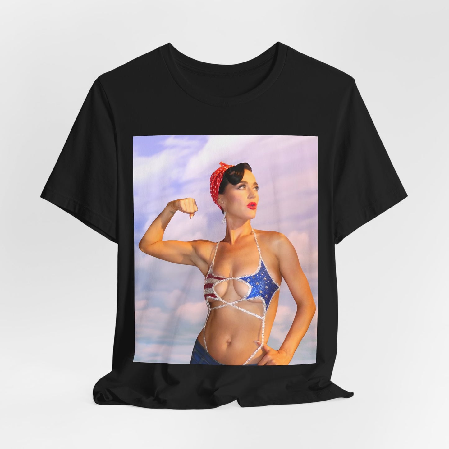 A black graphic t-shirt featuring a bold graphic of Katy Perry as a pop superstar.