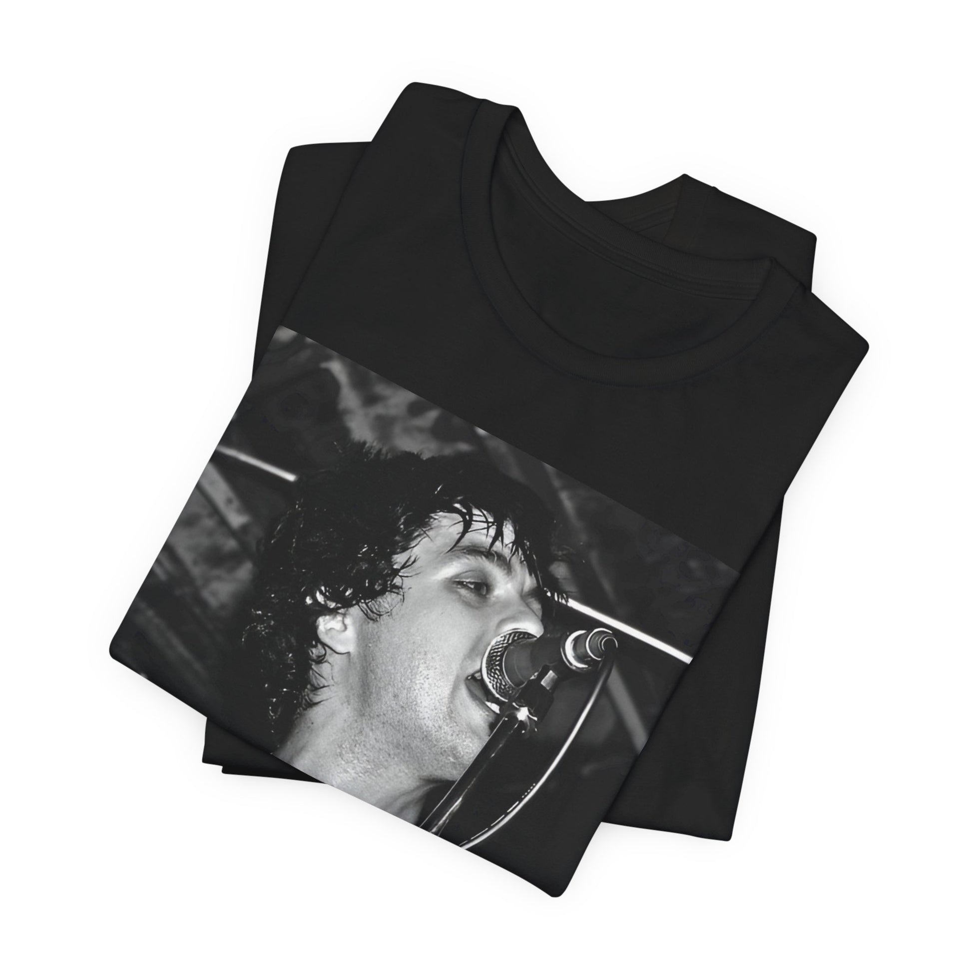 A black graphic t-shirt featuring a black and white graphic or photo of Green Day performing live on stage.