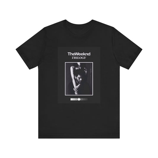 A black graphic t-shirt featuring a graphic related to The Weeknd's 'Trilogy' album.