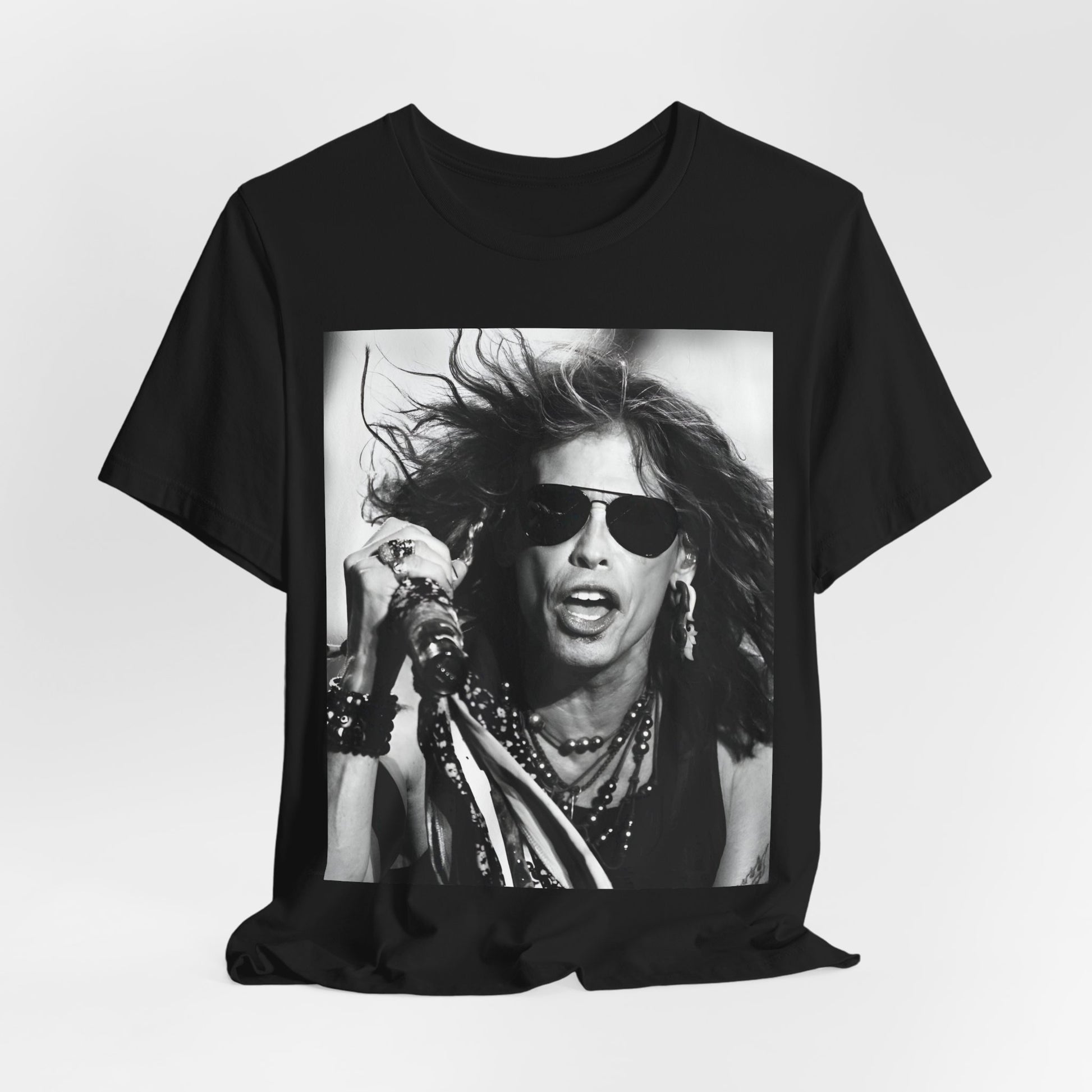 A black graphic t-shirt featuring a black and white photo of Aerosmith's Steven Tyler with his signature scarf and microphone, captured during a dynamic performance.