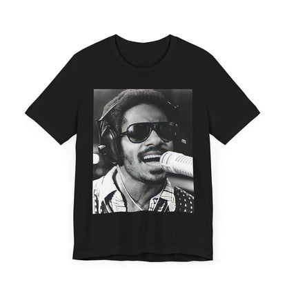 A black graphic t-shirt featuring a graphic of Stevie Wonder as a timeless visionary.