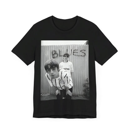 A black graphic t-shirt featuring a graphic of Liam and Noel Gallagher from Oasis, showing their support for Manchester City.