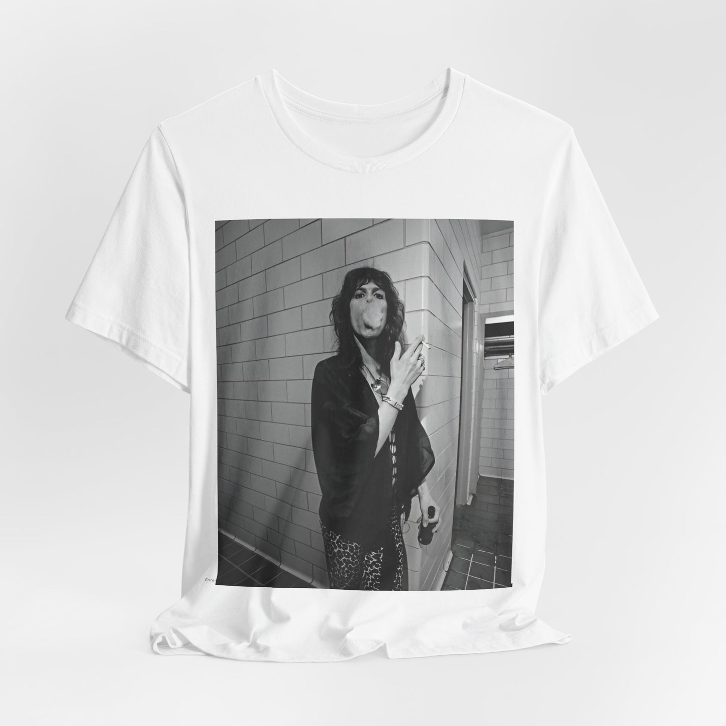 A black graphic t-shirt featuring a retro 70s photo of Aerosmith band members in a backstage setting, showing a candid moment.