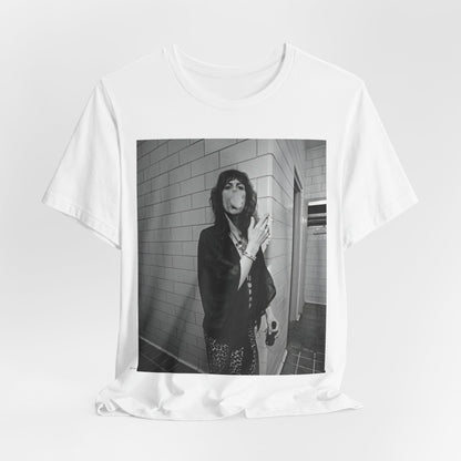 A black graphic t-shirt featuring a retro 70s photo of Aerosmith band members in a backstage setting, showing a candid moment.