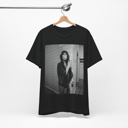 A black graphic t-shirt featuring a retro 70s photo of Aerosmith band members in a backstage setting, showing a candid moment.
