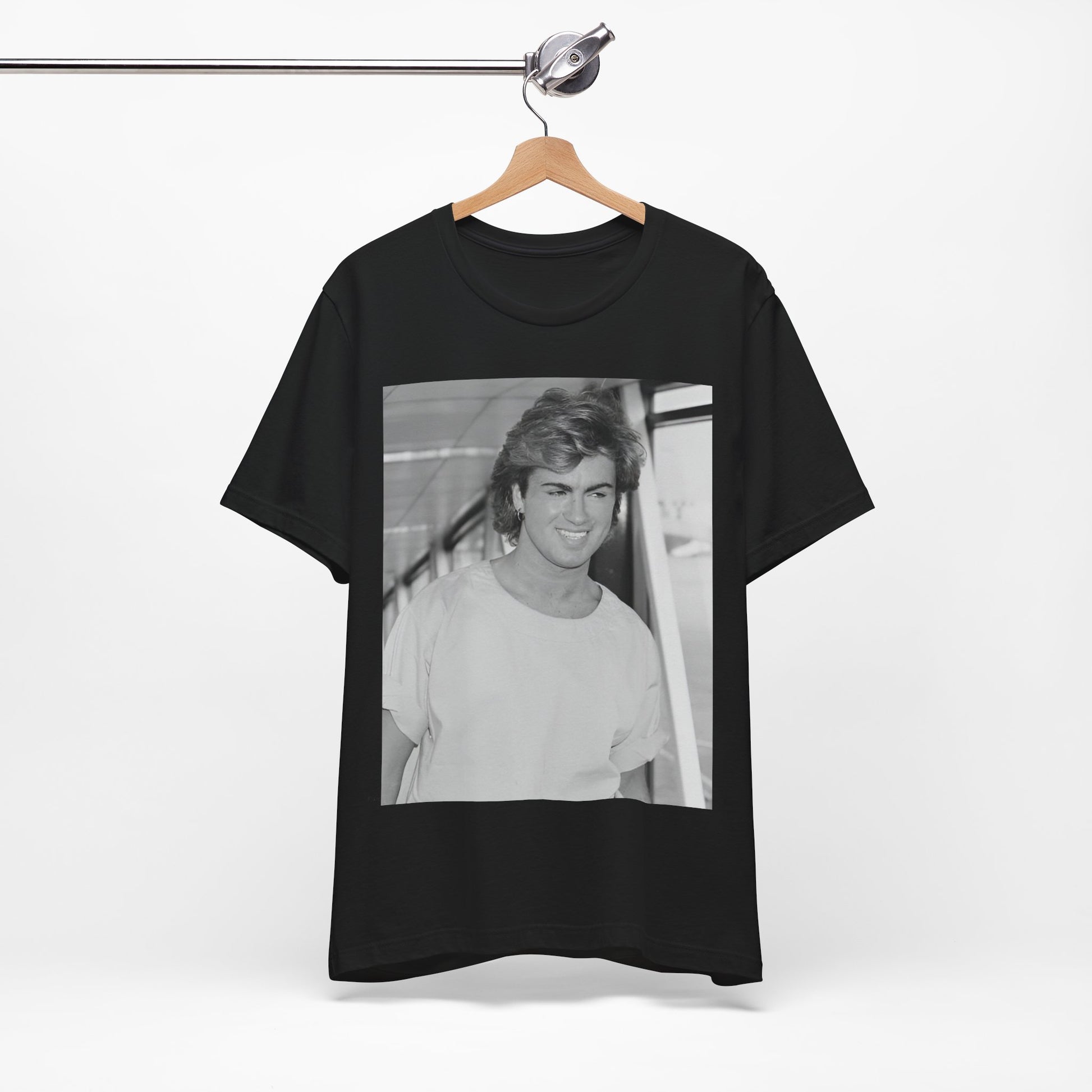 A black graphic t-shirt featuring an 80s black and white vintage photo or graphic of George Michael.
