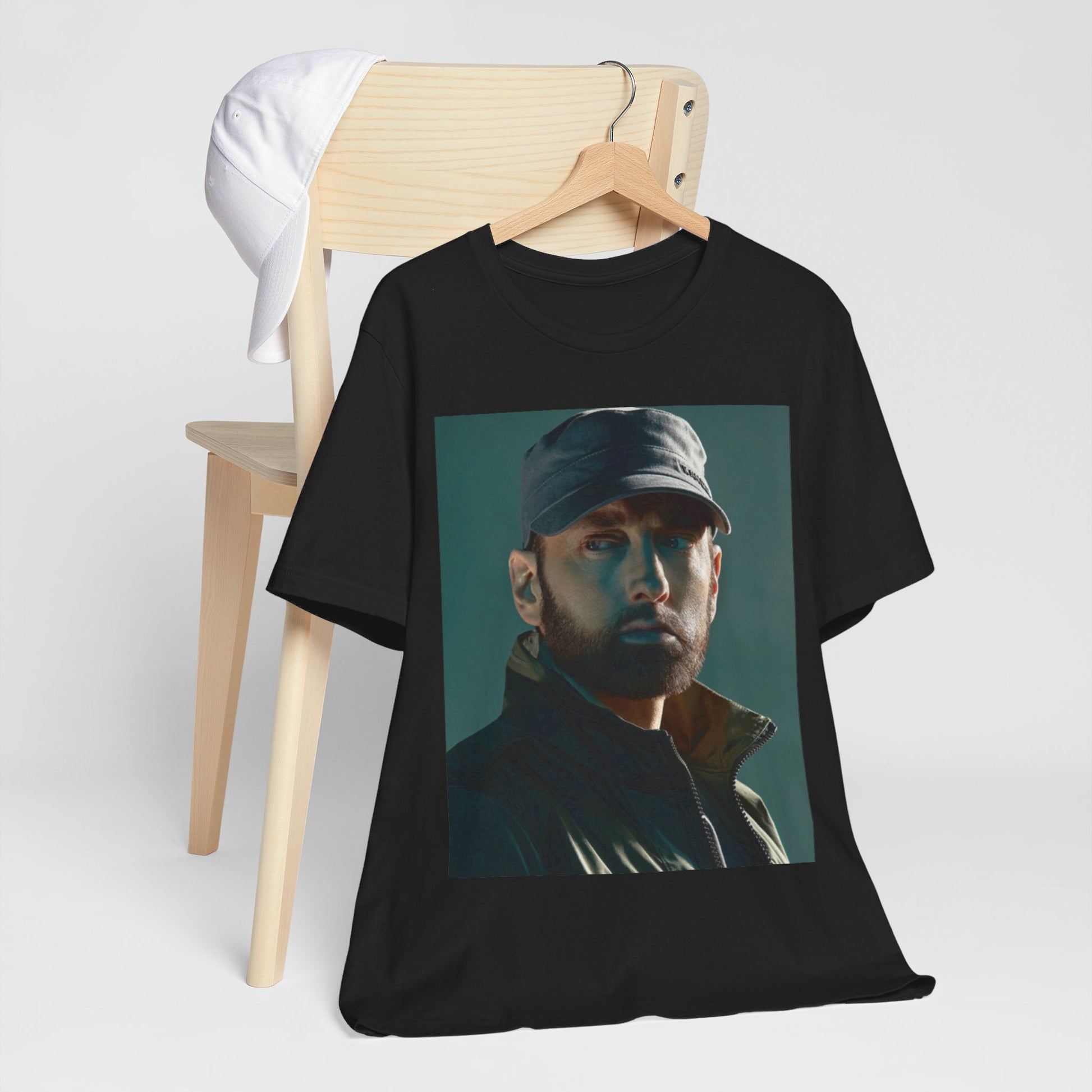 A black graphic t-shirt featuring a graphic of Eminem as a rap genius.