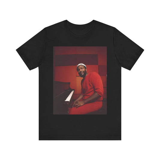 A black graphic t-shirt featuring a retro photo of Marvin Gaye playing the piano.
