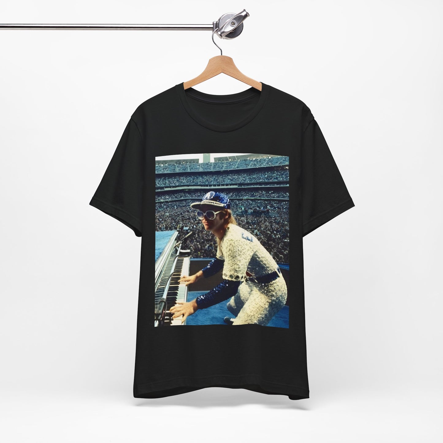 A black graphic t-shirt featuring a photo of Elton John from his 1975 Dodgers Stadium concert.