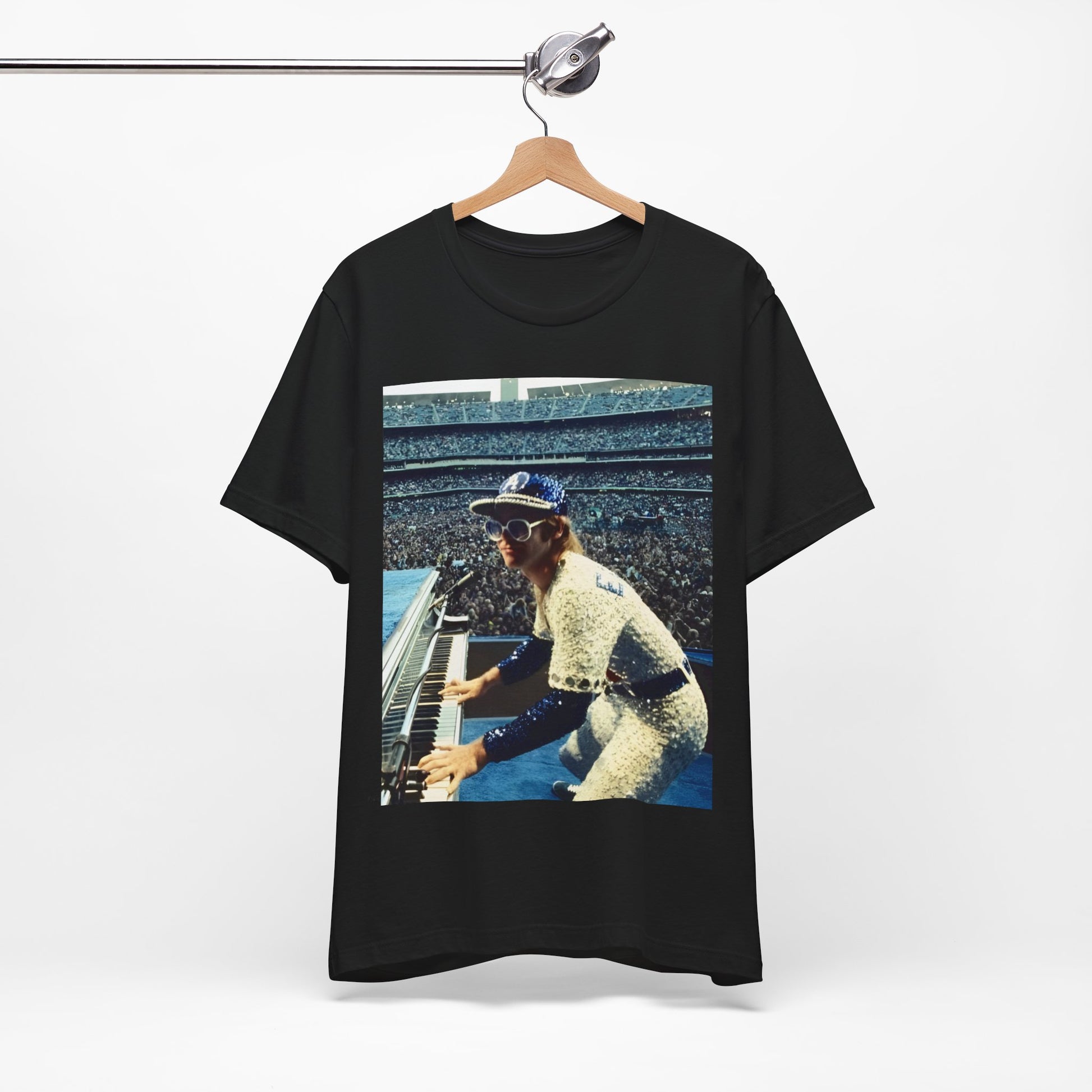 A black graphic t-shirt featuring a photo of Elton John from his 1975 Dodgers Stadium concert.