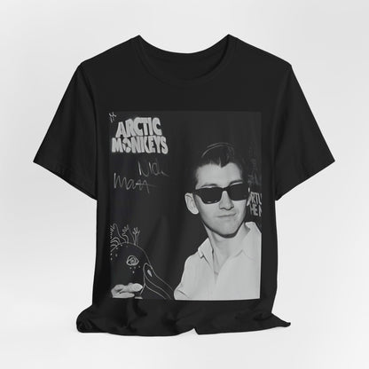 A black graphic t-shirt featuring a black and white portrait photo of Alex Turner from Arctic Monkeys, showing his signature look.