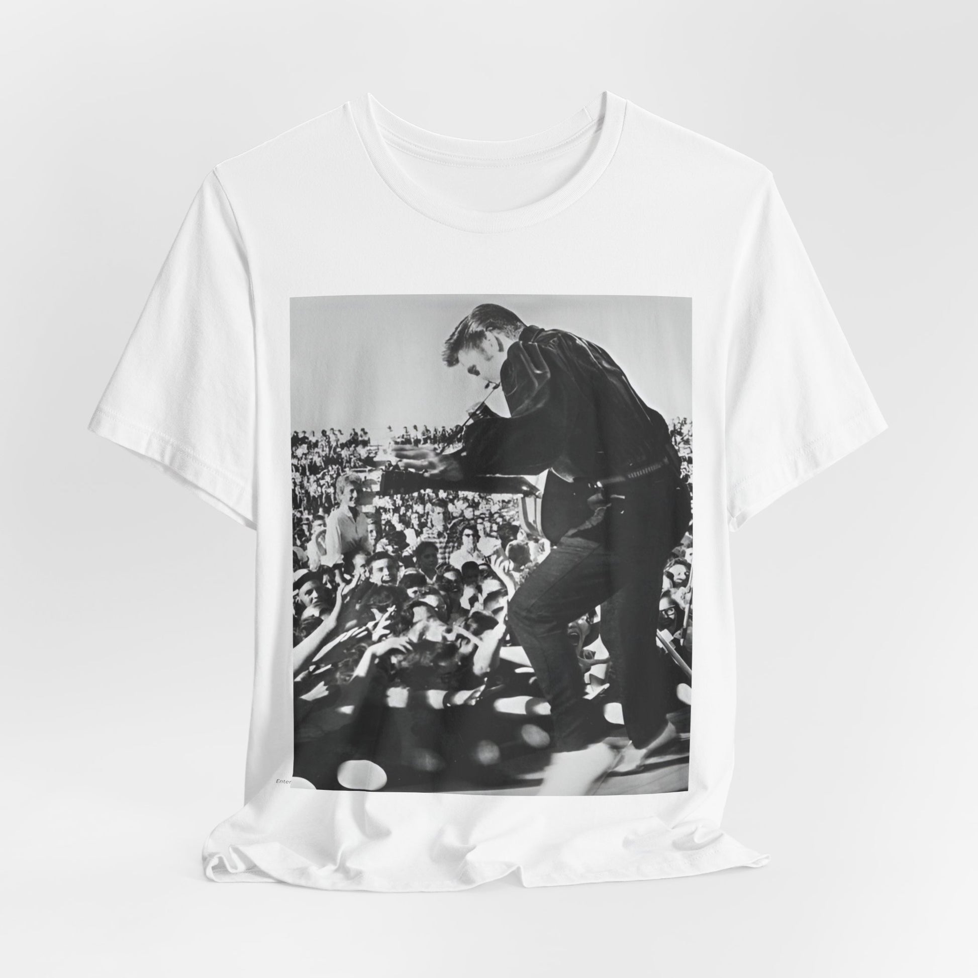 A black graphic t-shirt featuring a retro photo of Elvis Presley performing live in concert in the 1950s.