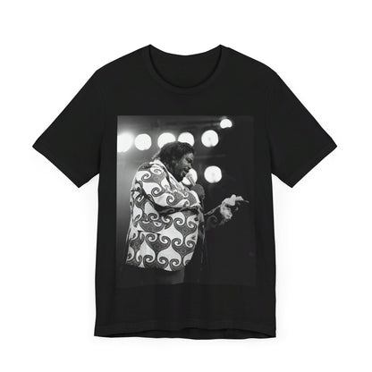 A black graphic t-shirt featuring a graphic or photo of Barry White performing live on stage in the 1970s.