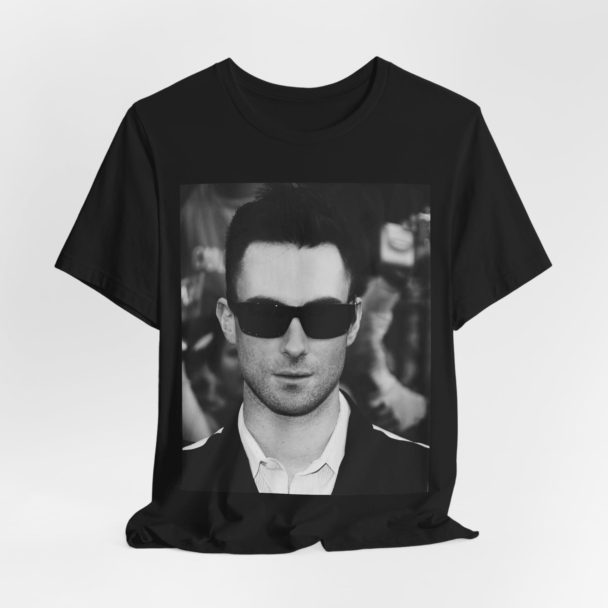 A black and white high-fashion photoshoot photo of Adam Levine, frontman of Maroon 5, looking confidently at the camera.