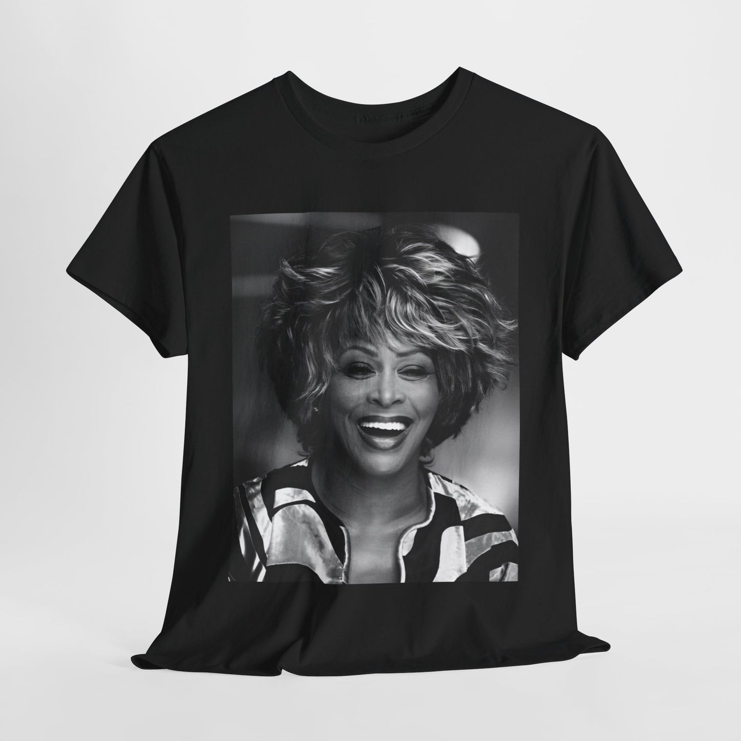 A black graphic t-shirt featuring a classic 80s pop aesthetic graphic of Tina Turner.