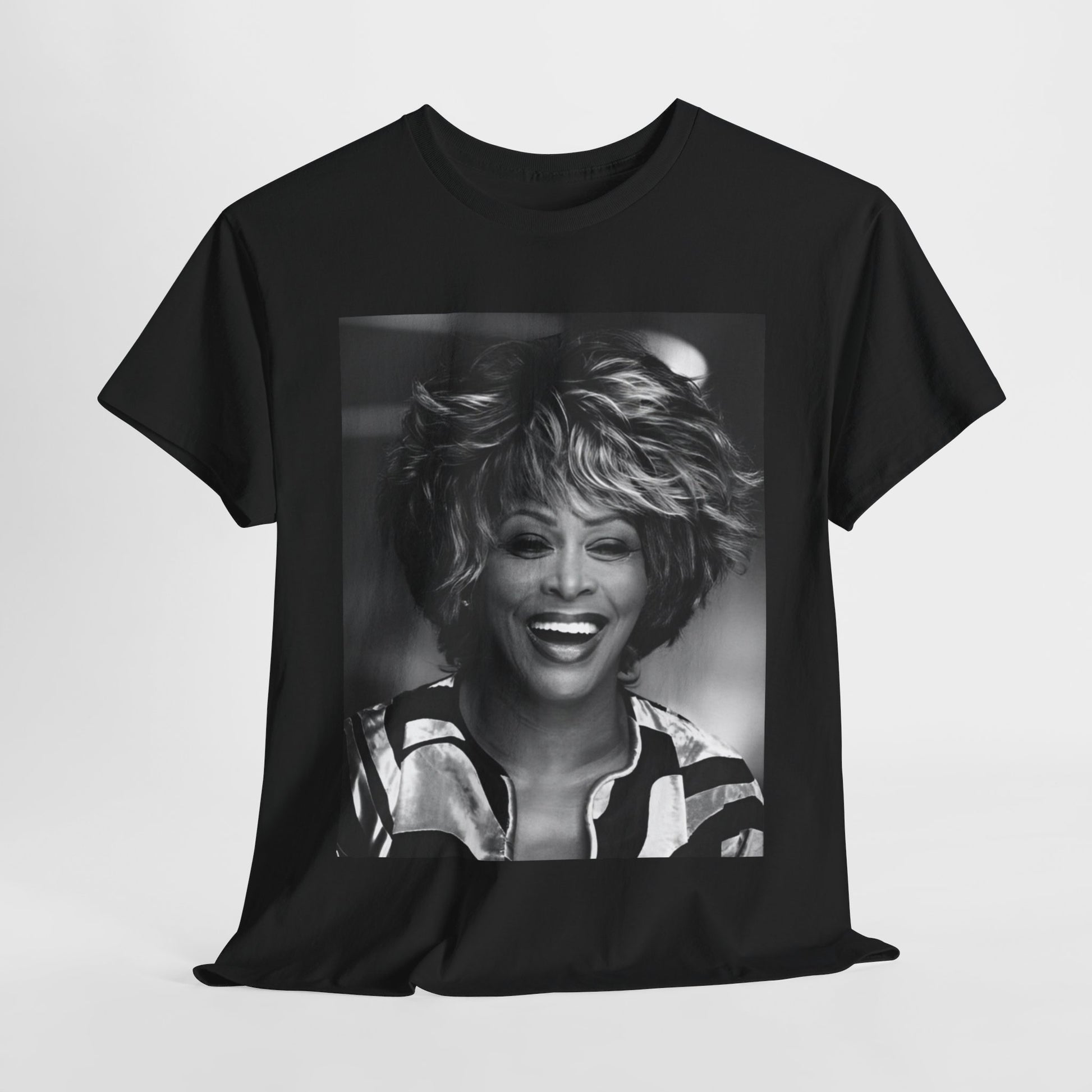 A black graphic t-shirt featuring a classic 80s pop aesthetic graphic of Tina Turner.
