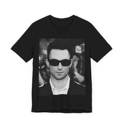 A black and white high-fashion photoshoot photo of Adam Levine, frontman of Maroon 5, looking confidently at the camera.