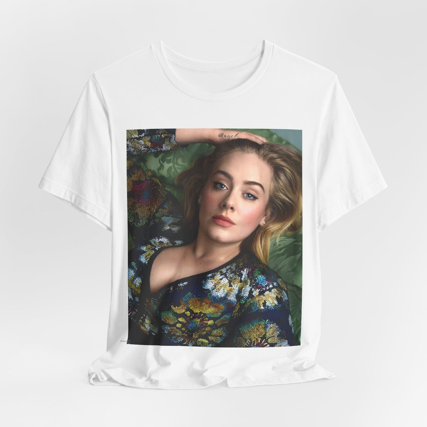 A black graphic t-shirt featuring a photo of Adele, possibly with floral elements or a floral background, showing a serene or contemplative expression.