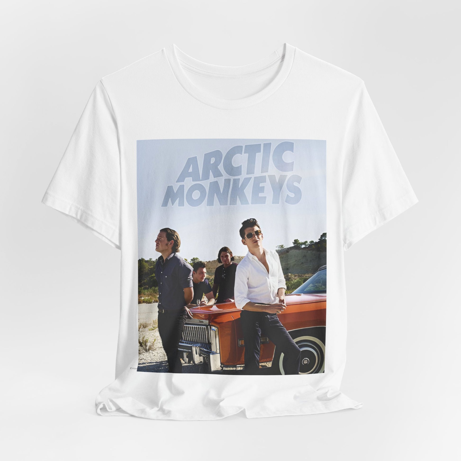 A black graphic t-shirt featuring a design related to Arctic Monkeys' 'AM' album era, possibly with the album art or band imagery.