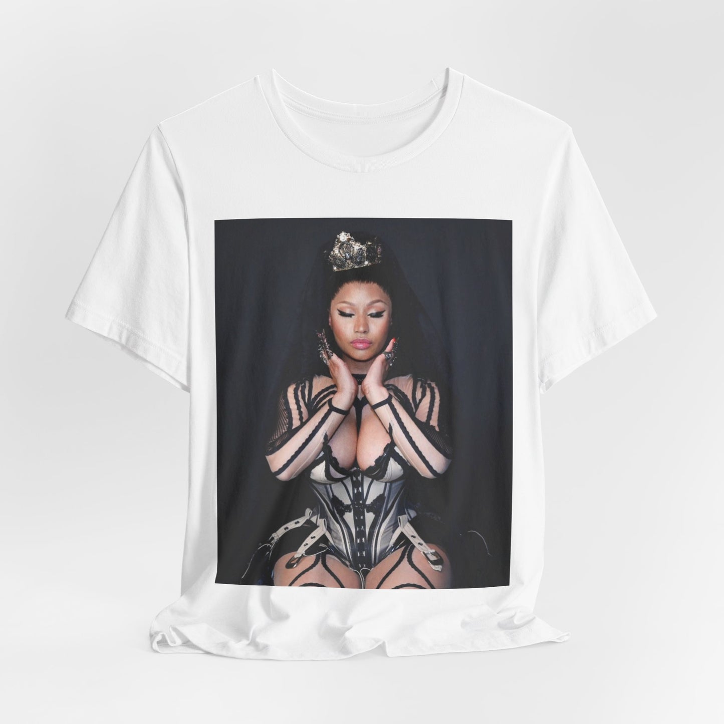 A black graphic t-shirt featuring a vintage graphic of Nicki Minaj as the Queen of Rap.