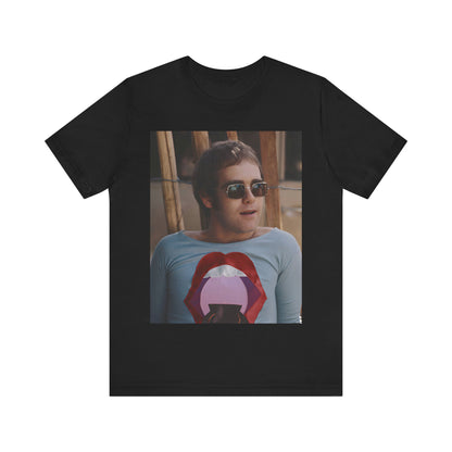 A black graphic t-shirt featuring a classic graphic related to Elton John's 'Tiny Dancer' song or era.