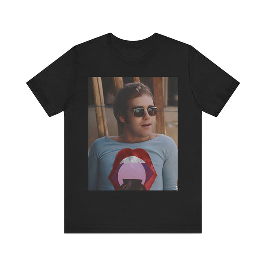 A black graphic t-shirt featuring a classic graphic related to Elton John's 'Tiny Dancer' song or era.