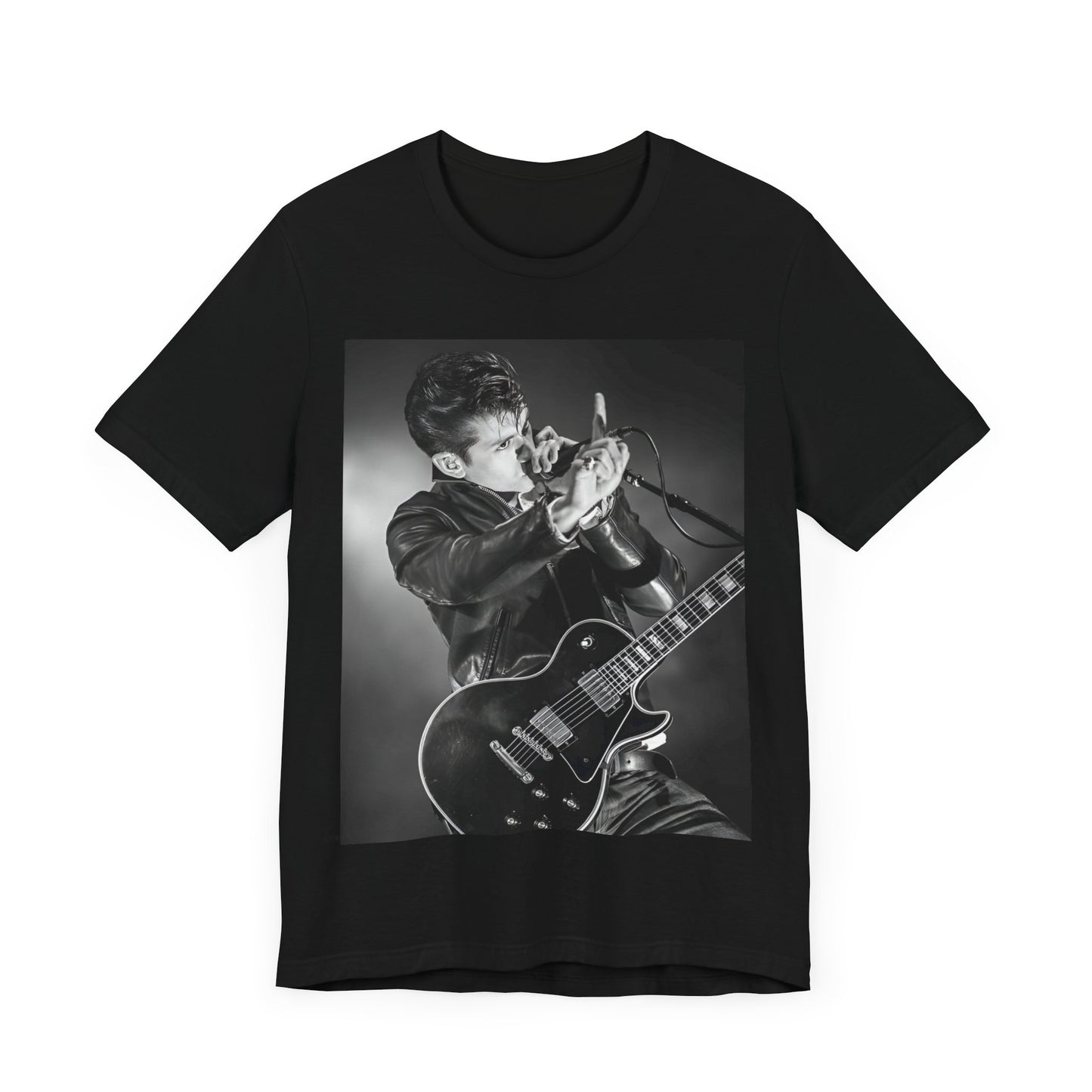 A black graphic t-shirt featuring a dynamic black and white graphic or photo of Arctic Monkeys performing live, emphasizing energy.