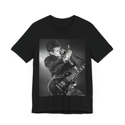 A black graphic t-shirt featuring a dynamic black and white graphic or photo of Arctic Monkeys performing live, emphasizing energy.