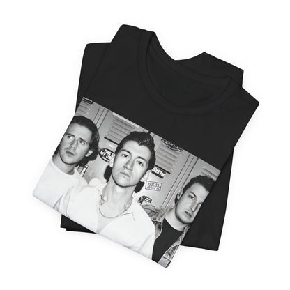 A black graphic t-shirt featuring a vintage-style design related to Arctic Monkeys' 'AM' album era, possibly with the album art or band imagery.