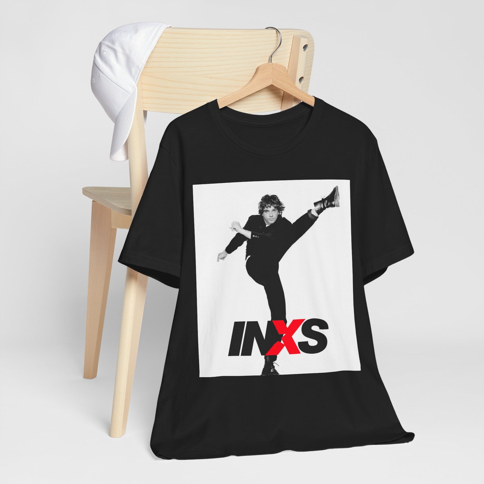 A black graphic t-shirt featuring a retro graphic related to INXS's 'Kick' album era.