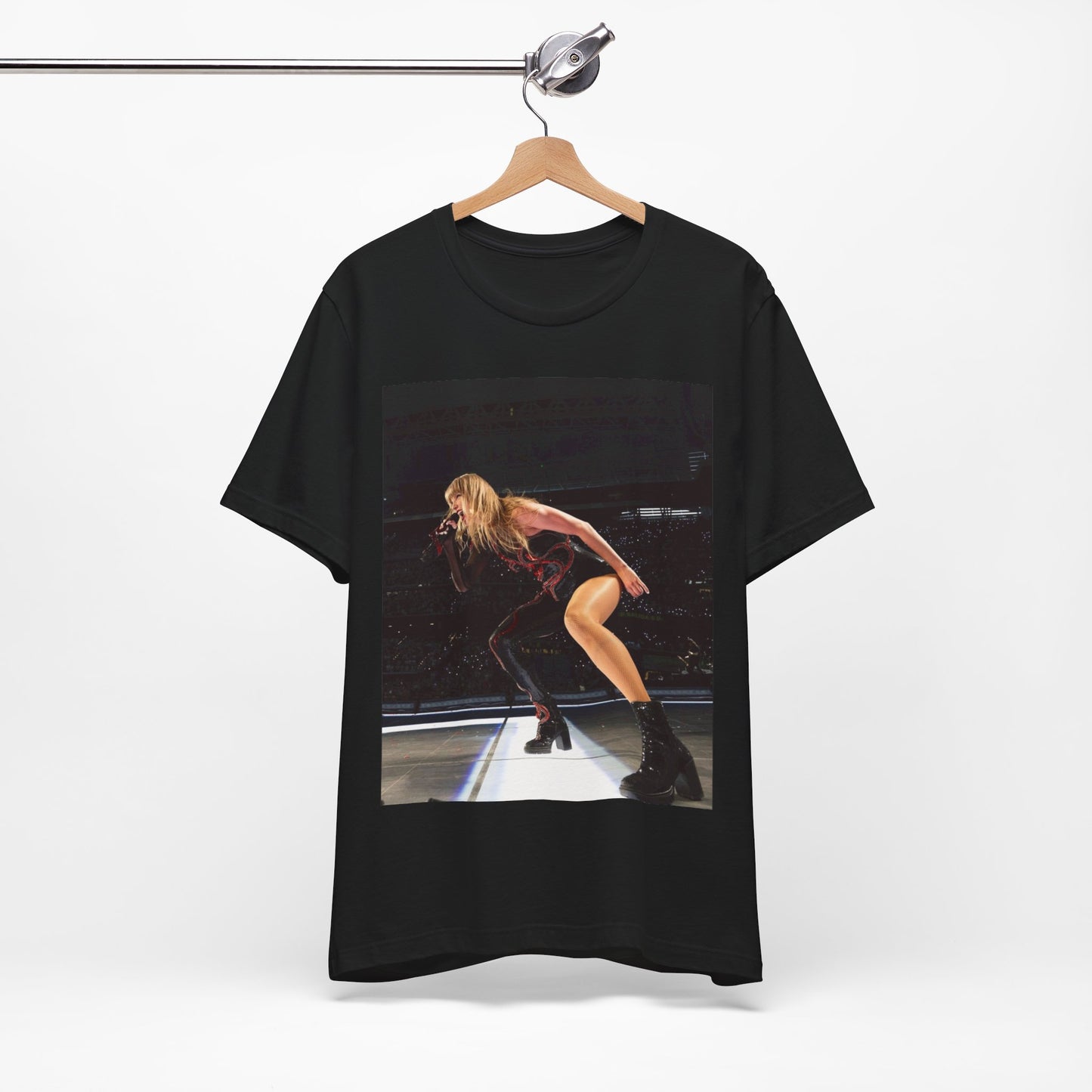 A black graphic t-shirt featuring a fierce graphic of Taylor Swift on stage.