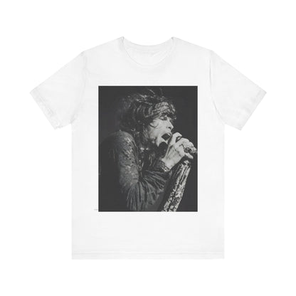 A black graphic t-shirt featuring a retro 70s-style illustration or photo of Aerosmith, designed to evoke their 'On Tour' presence, possibly with band members on stage or tour bus imagery.