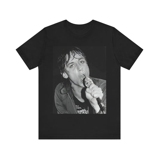 A black graphic t-shirt featuring a 70s graphic or photo of Iggy Pop performing in a wild concert.