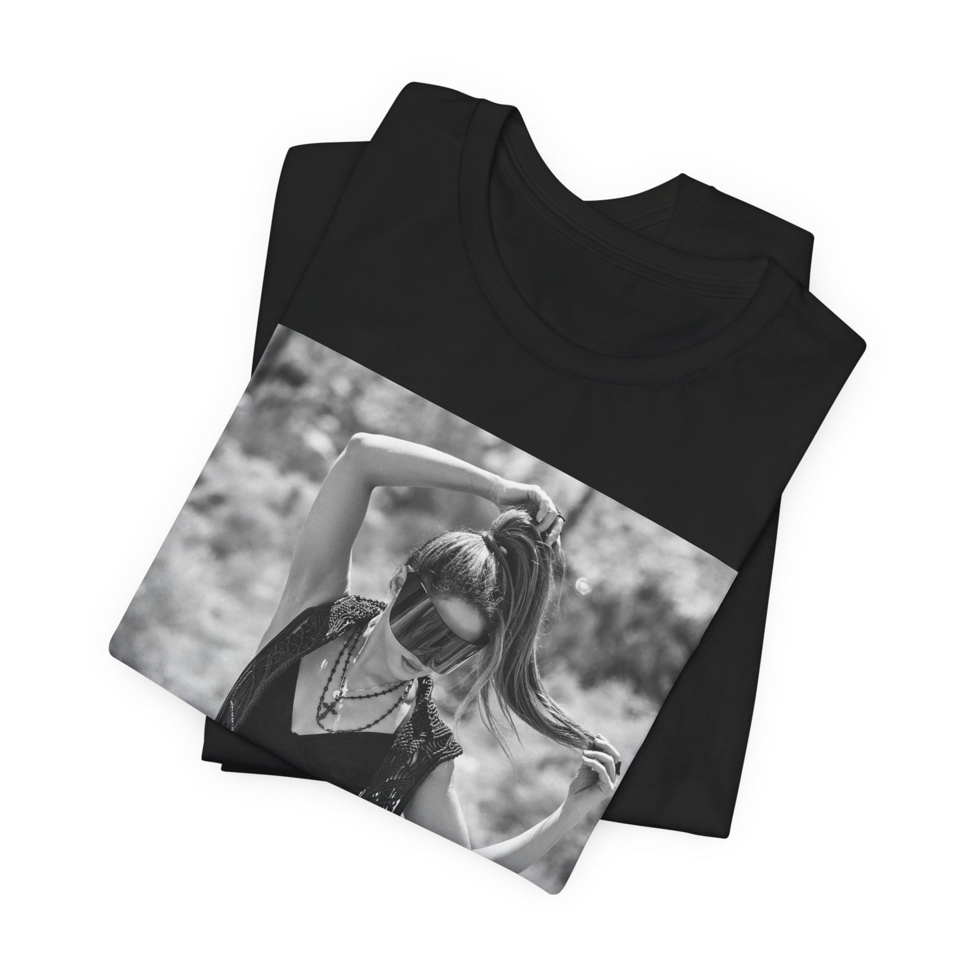 A black graphic t-shirt featuring a black and white, monochrome graphic or photo of Shakira.