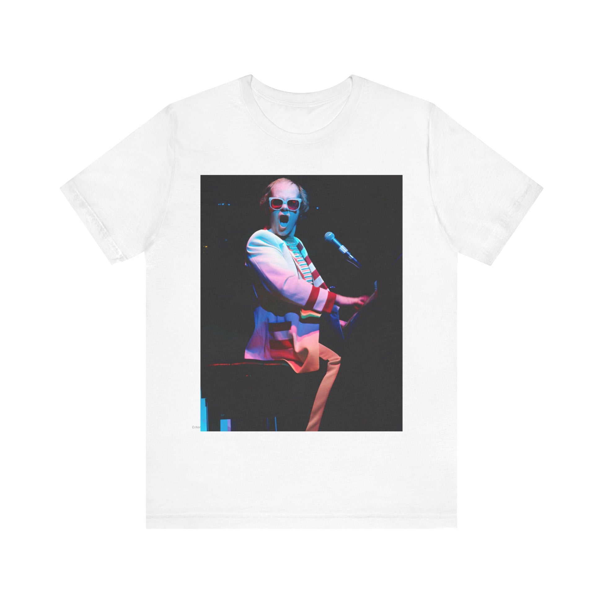 A black graphic t-shirt featuring a photo of Elton John performing live on stage at his piano.