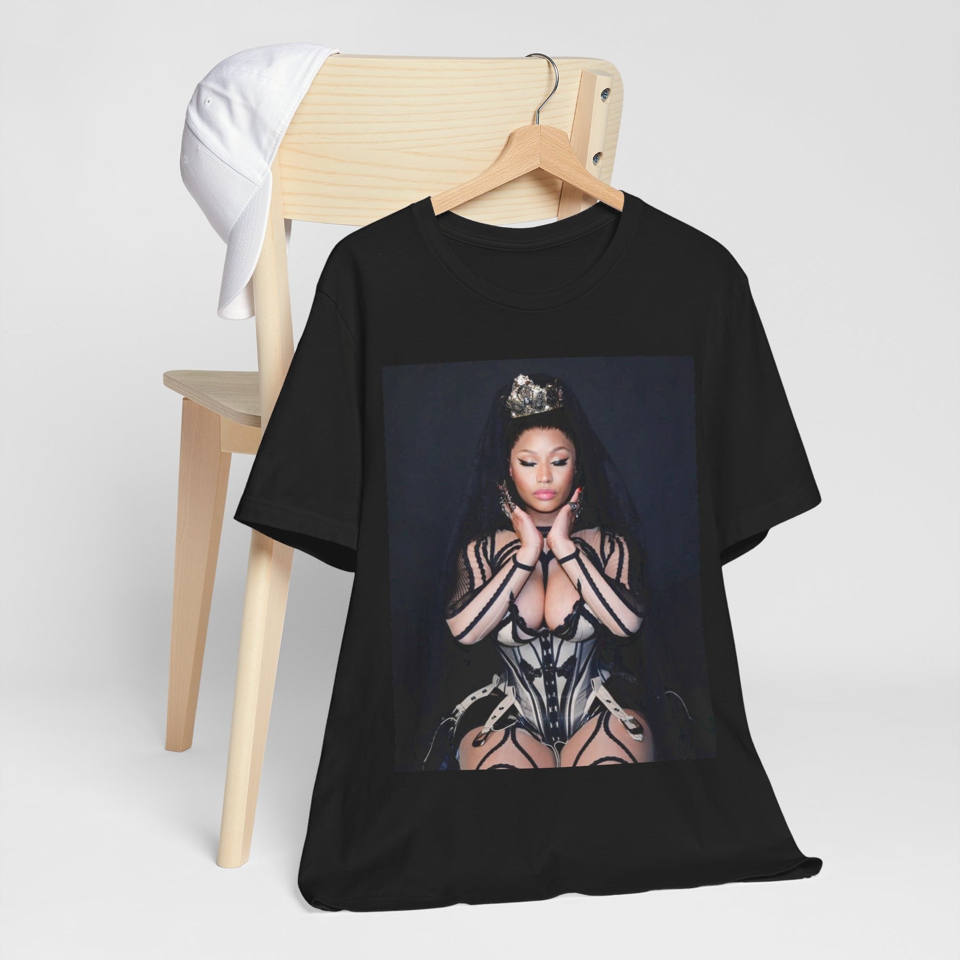 A black graphic t-shirt featuring a vintage graphic of Nicki Minaj as the Queen of Rap.