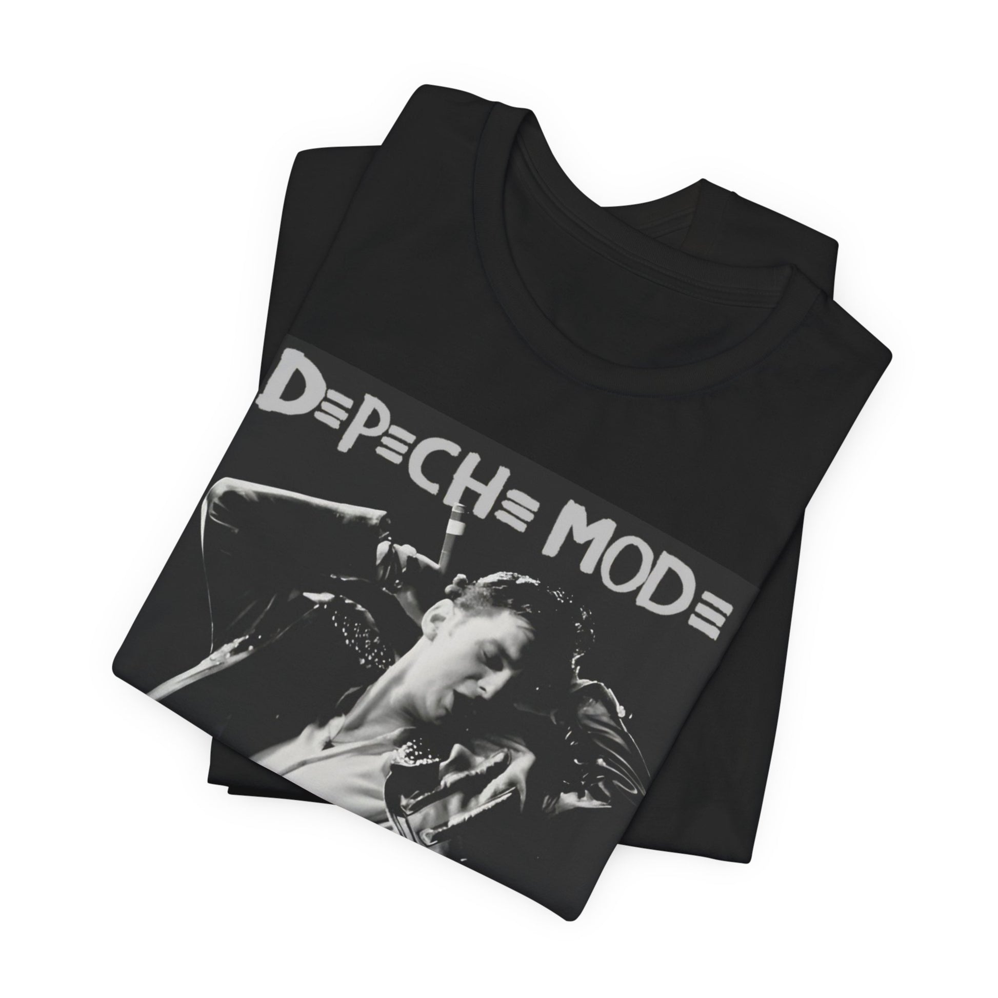 A black graphic t-shirt featuring a black and white graphic or photo of Depeche Mode performing live on stage.
