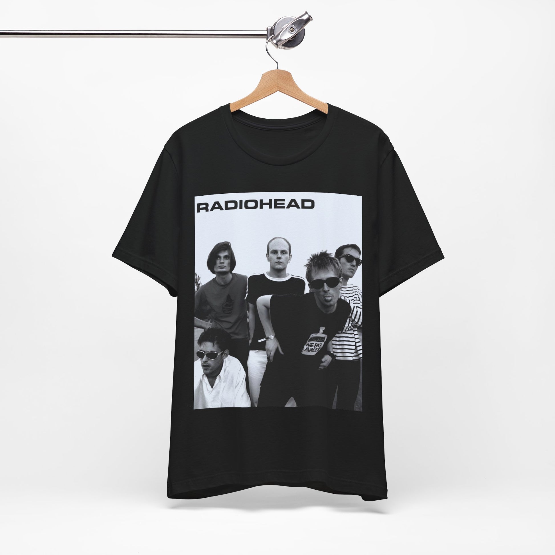 A black graphic t-shirt featuring a vintage 90s graphic related to Radiohead's 'Creep' song or era.