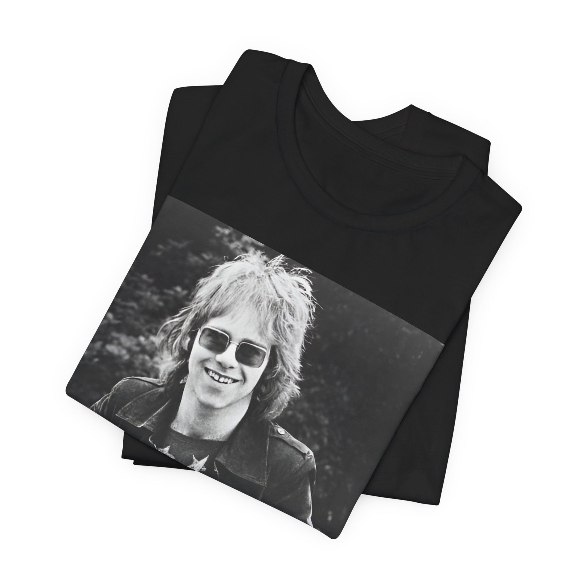 A black graphic t-shirt featuring a 70s black and white monochrome graphic or photo of Elton John.
