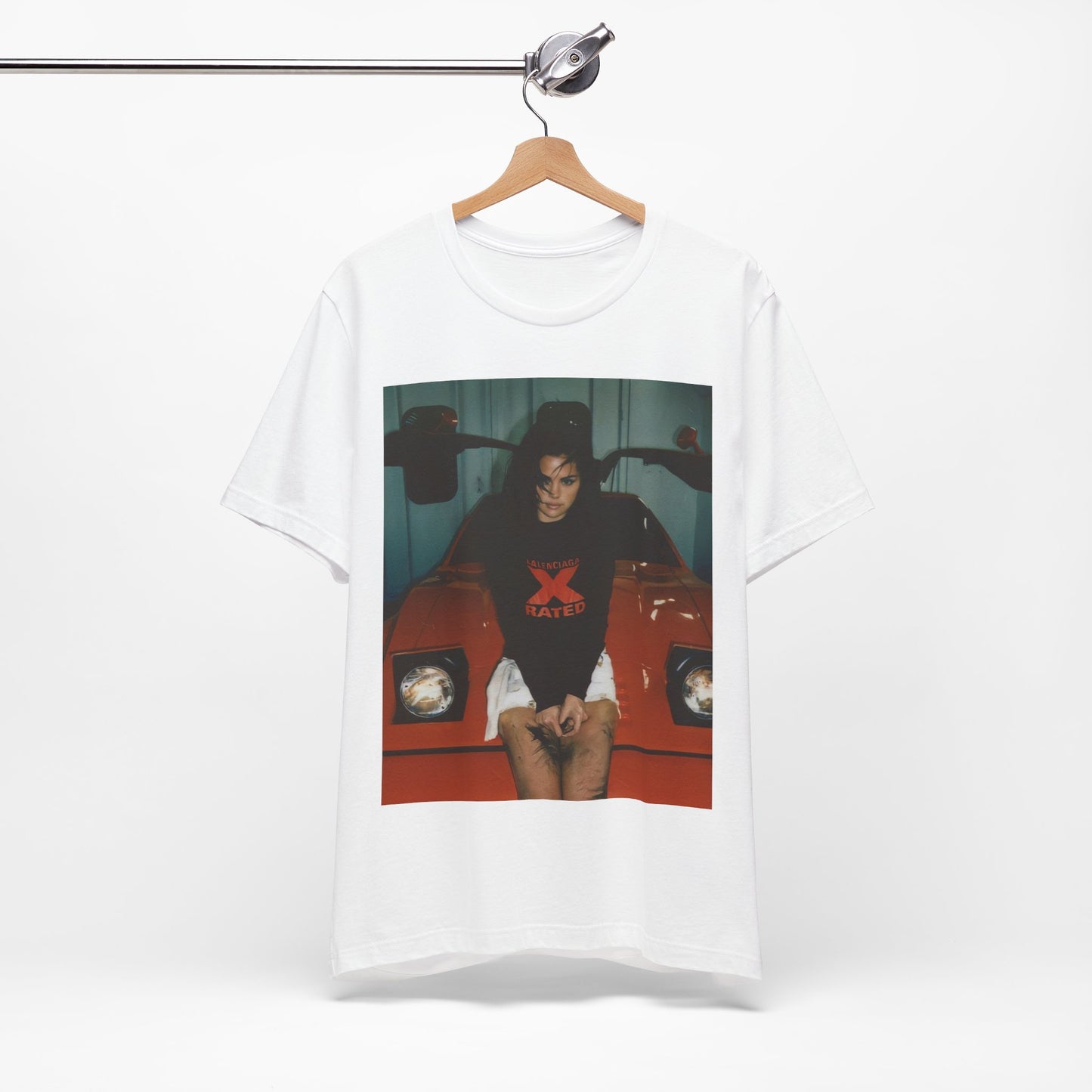 A black graphic t-shirt featuring a photo or graphic of Selena Gomez with a car, designed with an 'X Rated' or edgy aesthetic.